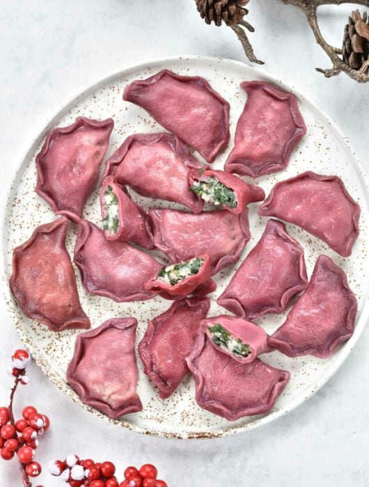 pink pierogi with spinach and potato filling