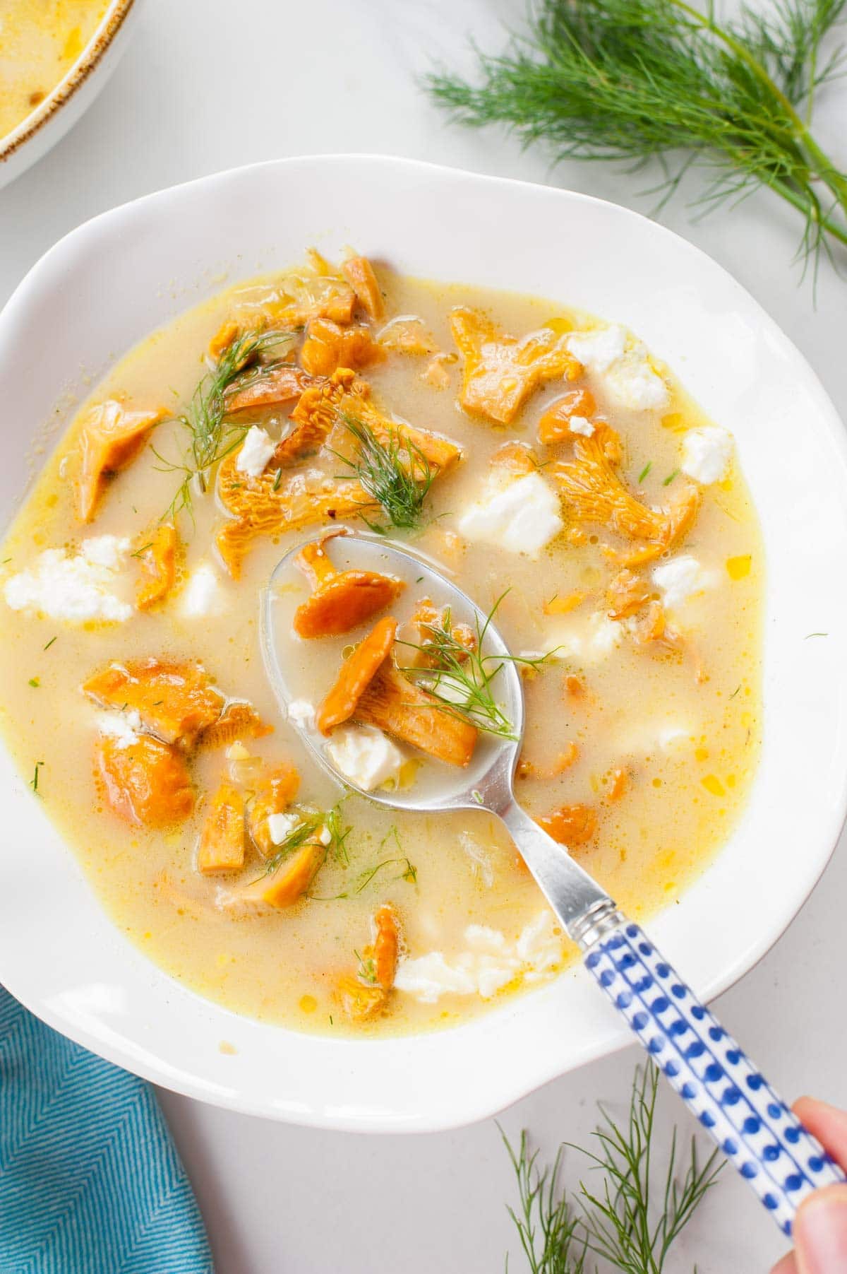 Chanterelle mushroom soup in a white bowl.