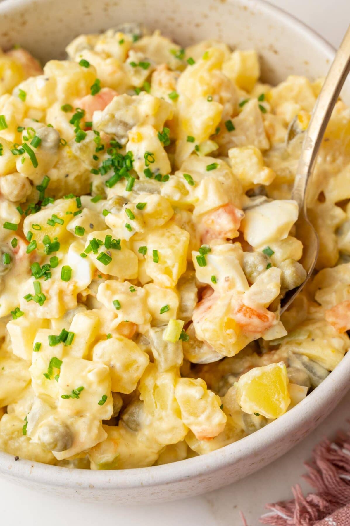 Polish salatka jarzynowa in a beige bowl.