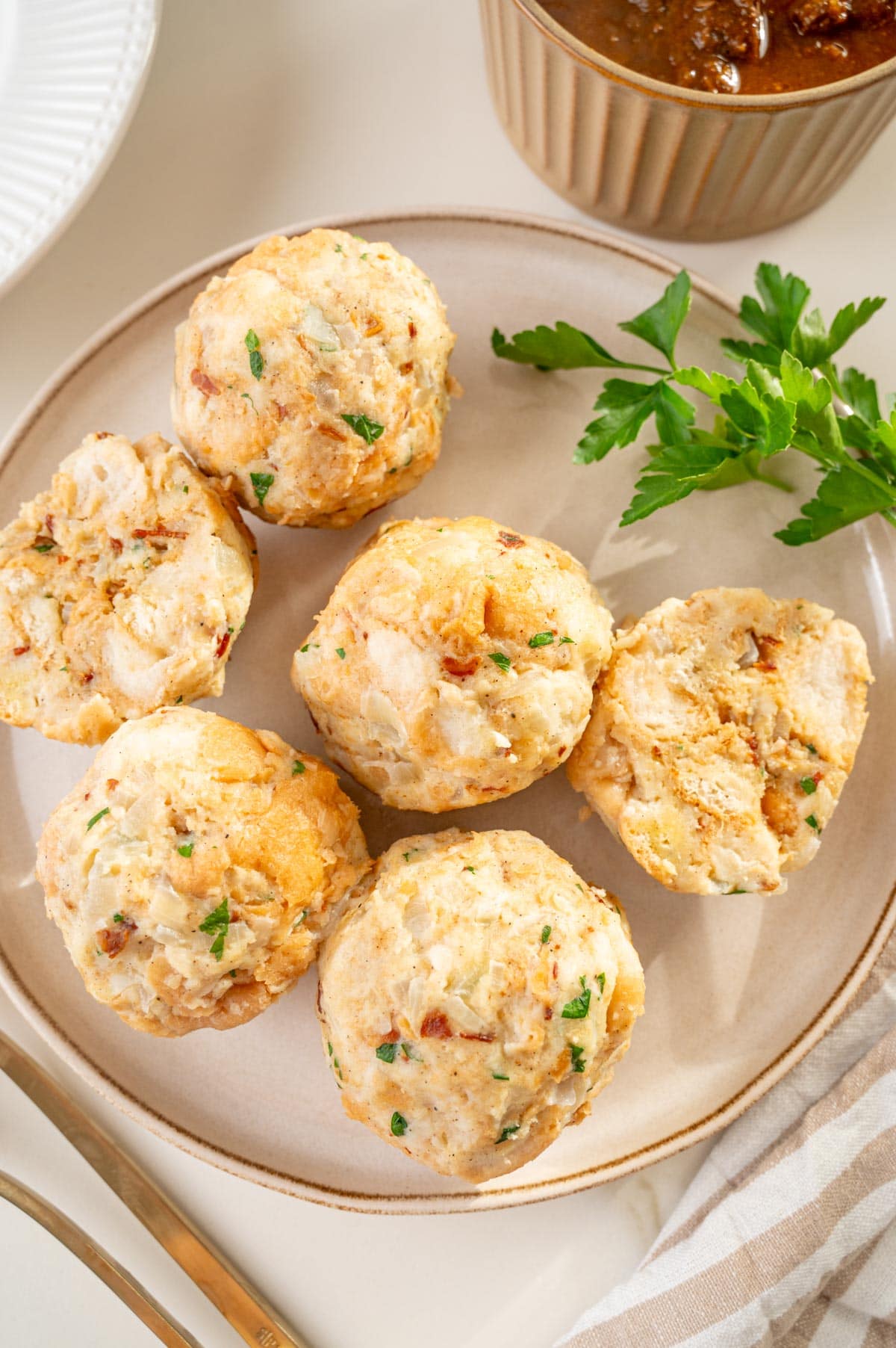 An overhead photo of Semmelknödel on a beige plate.