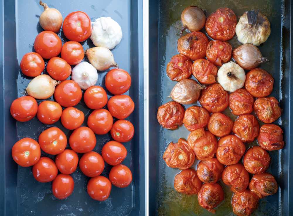 Uncooked tomatoes, onions, and garlic bulbs on a baking sheet. Roasted ingredients for a soup on a baking sheet.
