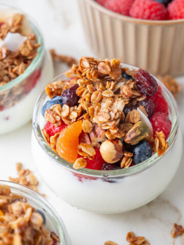 Small bowls with yogurt, berries, and granola.