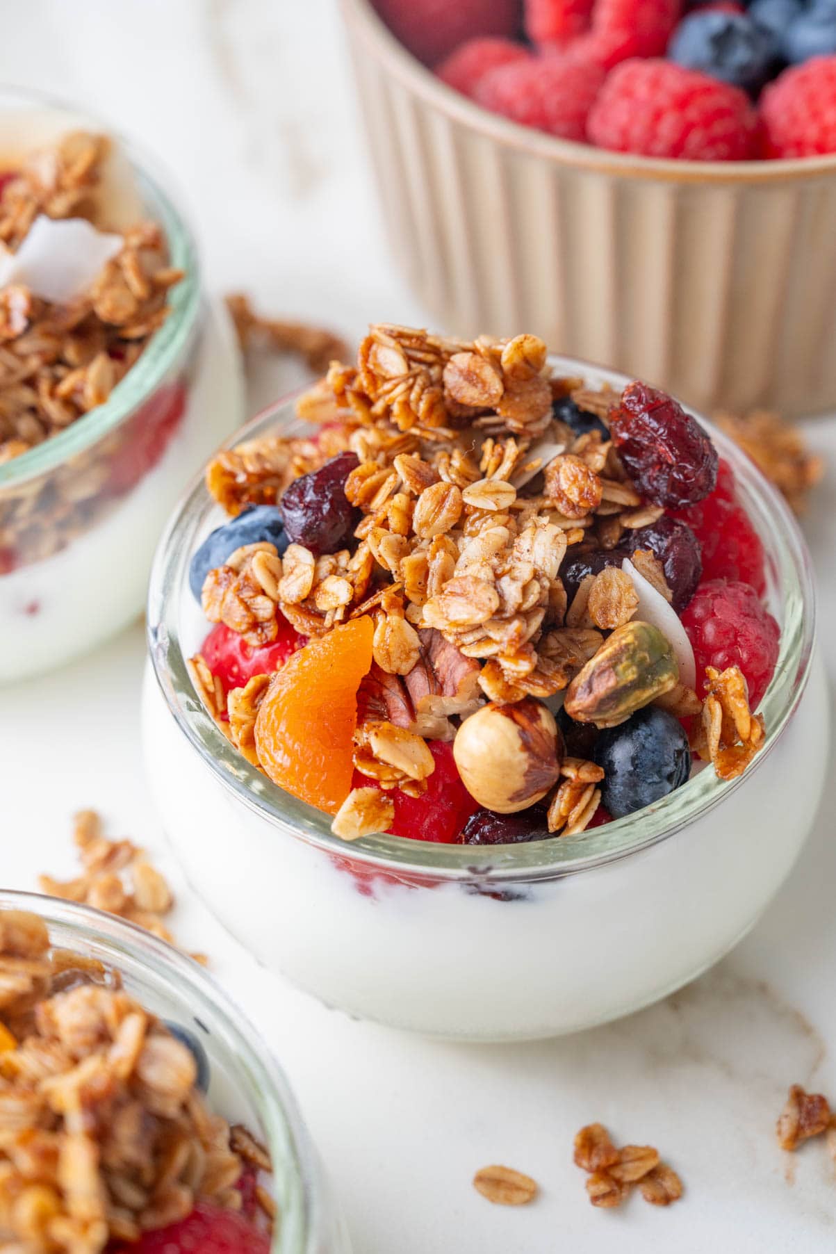 Small bowls with yogurt, berries, and granola.