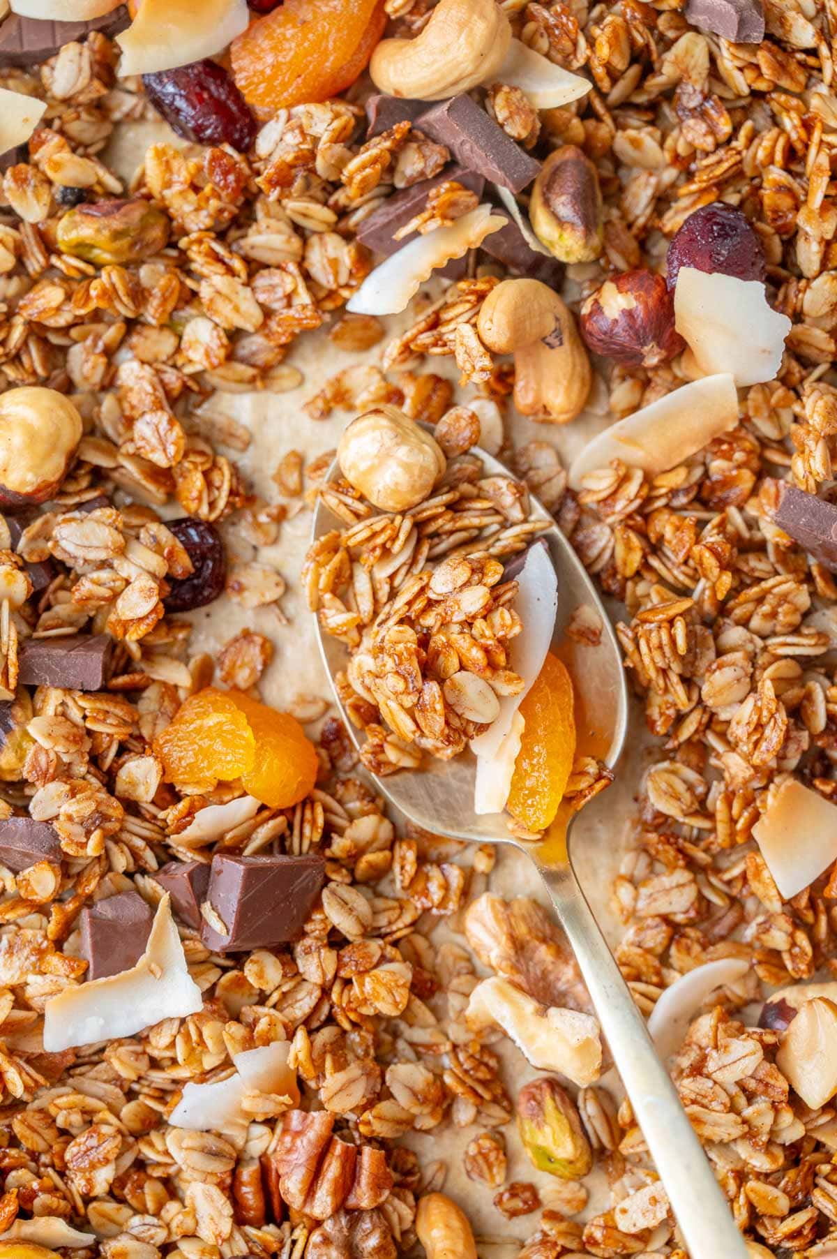 Overhead close-up photo of granola on a baking sheet.