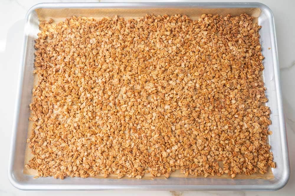 A thin layer of baked oats on a baking sheet.