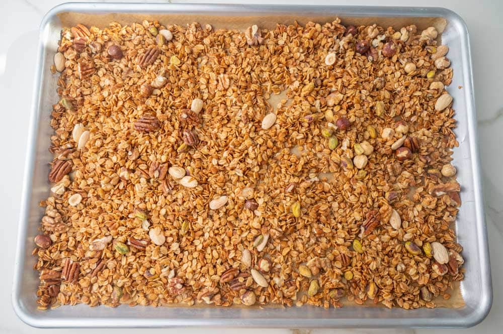 Baked oats with mixed nuts on a baking sheet.