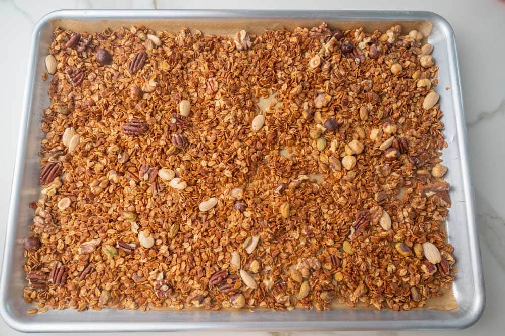 Baked oats with mixed nuts on a baking sheet.