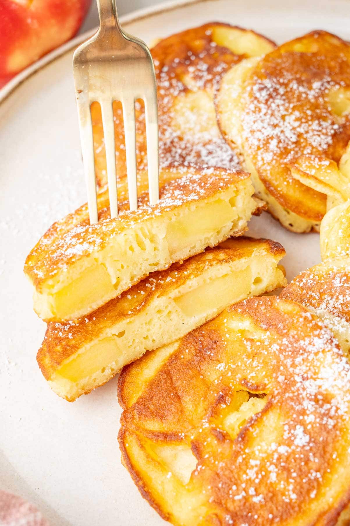 A close up photo of apple ring pancakes cut in half.