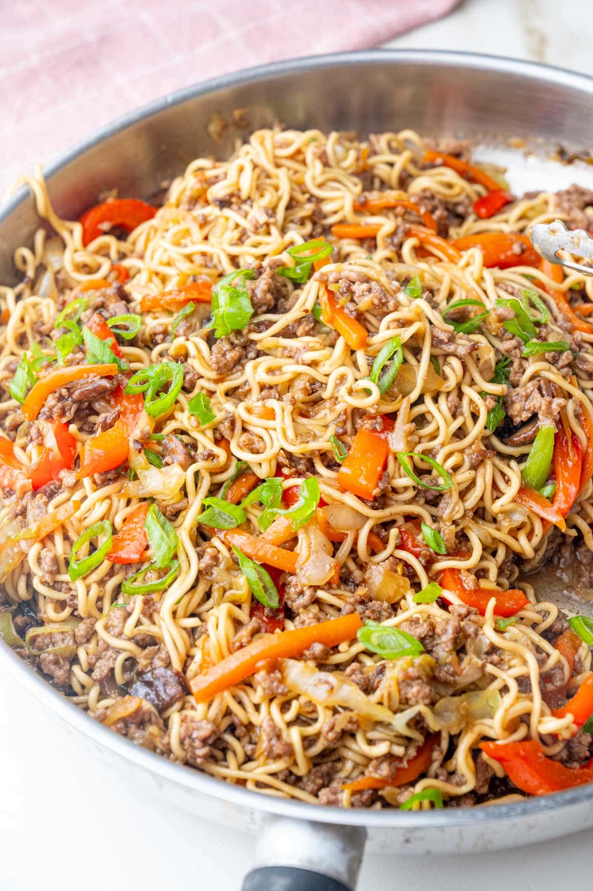 Ground beef noodles with vegetables in a pan.