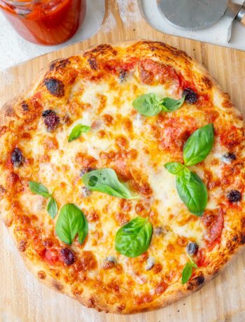 Overhead photo of pizza on a wooden board.