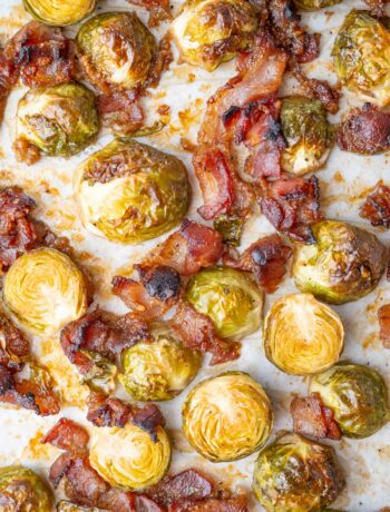 Roasted Brussels sprouts with bacon on a baking sheet.