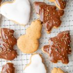 Polish pierniczki cookies decorated with icing and chocolate glaze on a cooling rack.