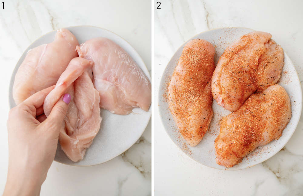 A hand is holding a chicken breast with a pocket inside it. Seasoned chicken breasts on a plate.